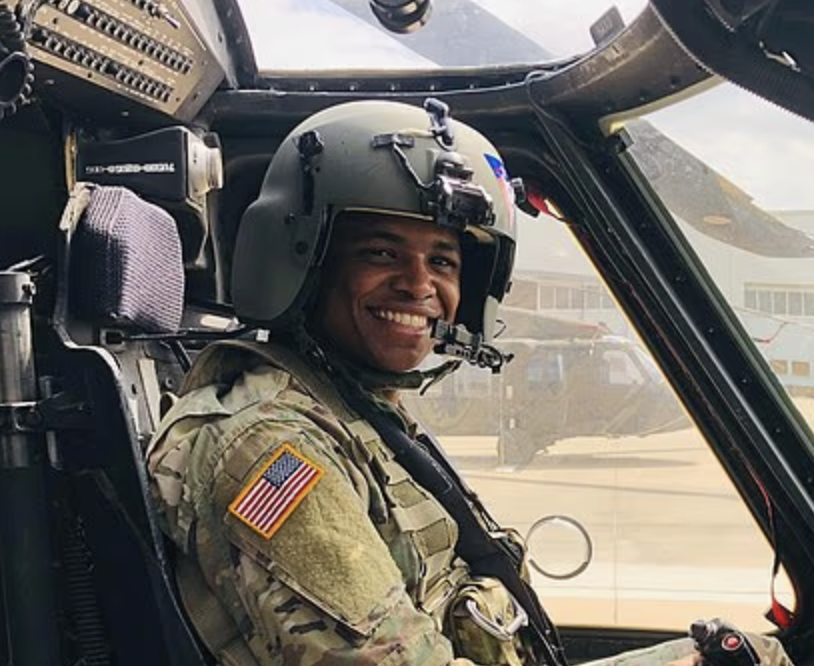 Stephanie Kenny-Velasquez and her husband Christopher Busby, an Army reservist and Black Hawk pilot, smiling together.